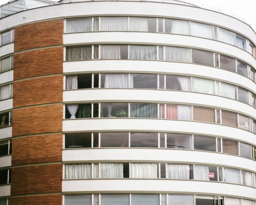 Person looking out of an apartment window in Bogota to rest from screen